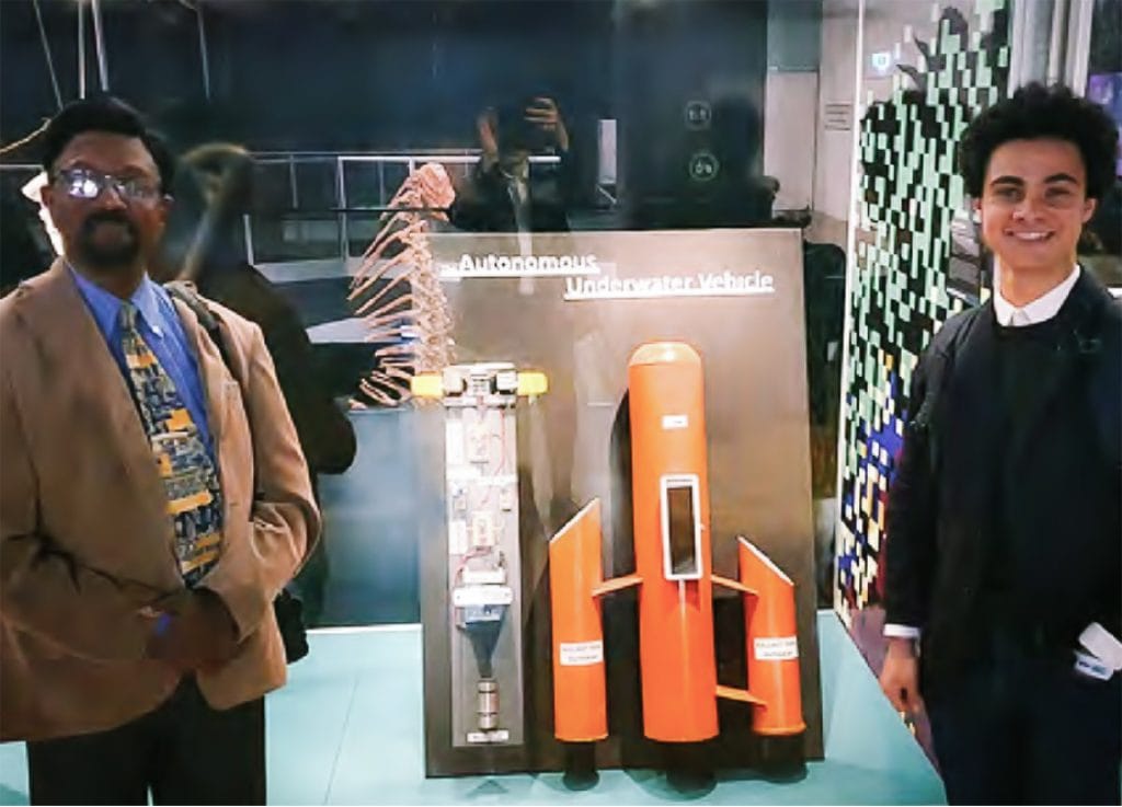 Micheal and Moses standing beside Moses's Autonomous Underwater Vehicle prototype at the 2021 TOP Designs Exhibition 